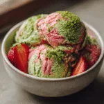 Strawberry matcha ice cream in rustic bowl with swirl
