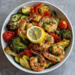 served sheet pan roasted shrimp and vegetables garnished with parsley and lemon