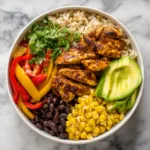 chicken fajita burrito bowl with rice avocado black beans corn and cilantro